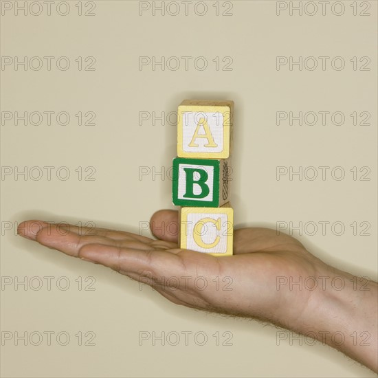Man holding ABC blocks.