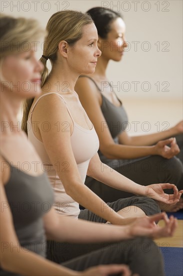 Multi-ethnic women practicing yoga.