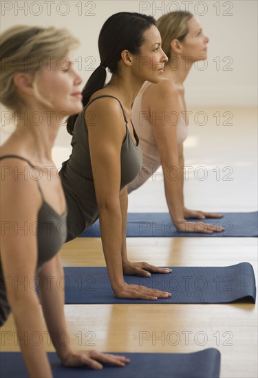 Multi-ethnic women practicing yoga.