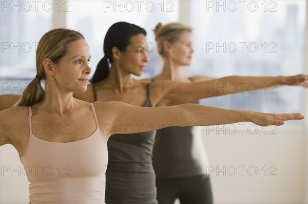 Multi-ethnic women practicing yoga.