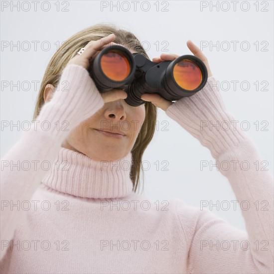 Woman looking through binoculars.