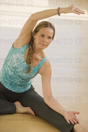 Woman stretching on floor.
