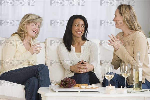 Multi-ethnic women laughing.