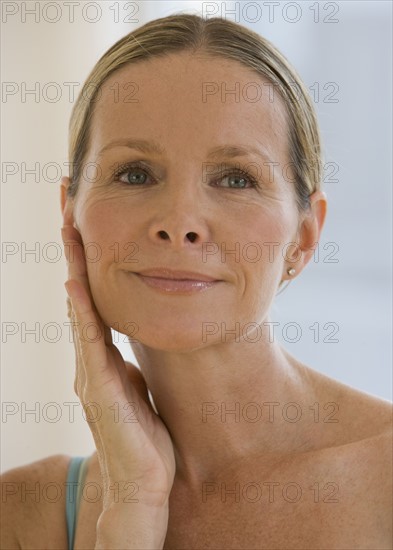 Woman hand on face.