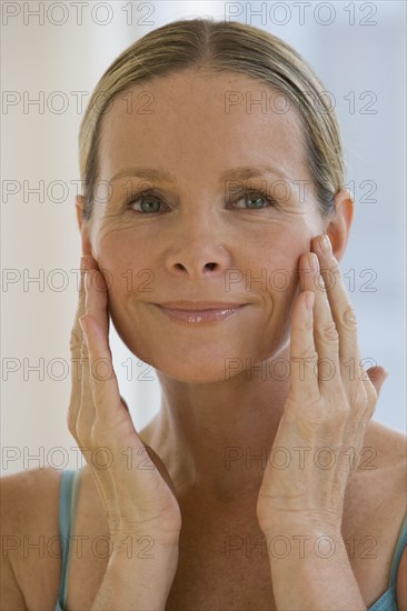 Woman with hands on face.