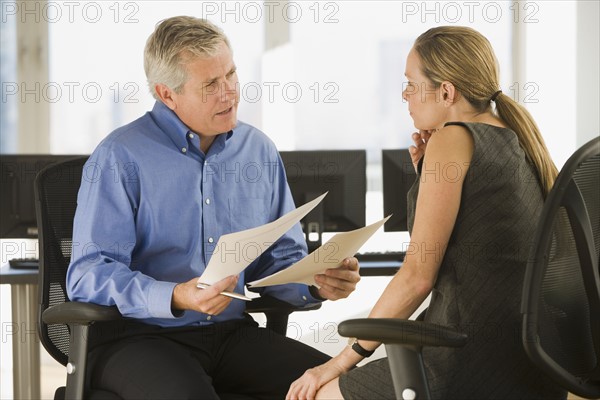 Businessman and businesswoman talking.