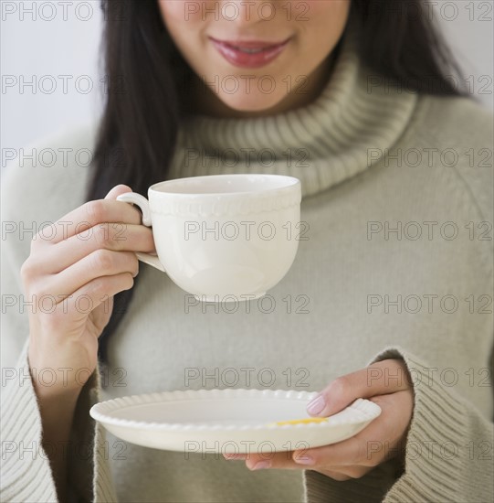 Woman drinking coffee.