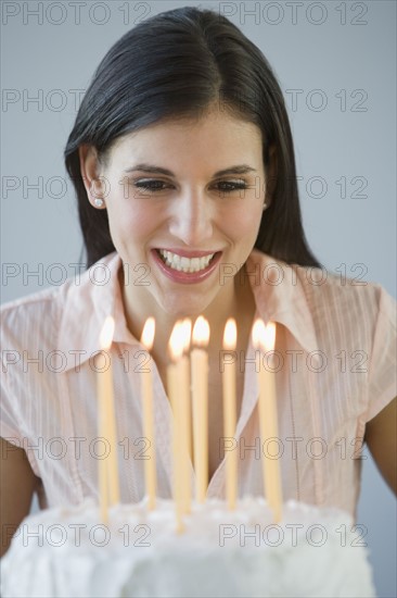 Woman looking at birthday cake.