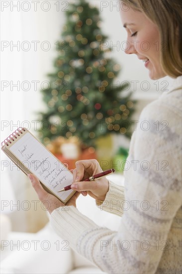 Woman writing list.