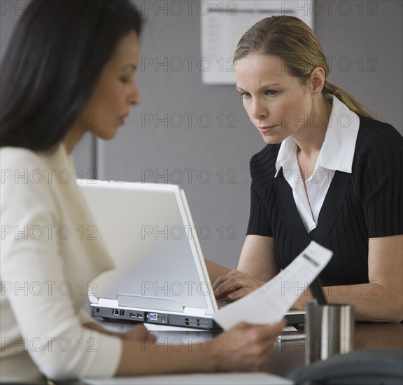 Multi-ethnic businesswomen working in office.