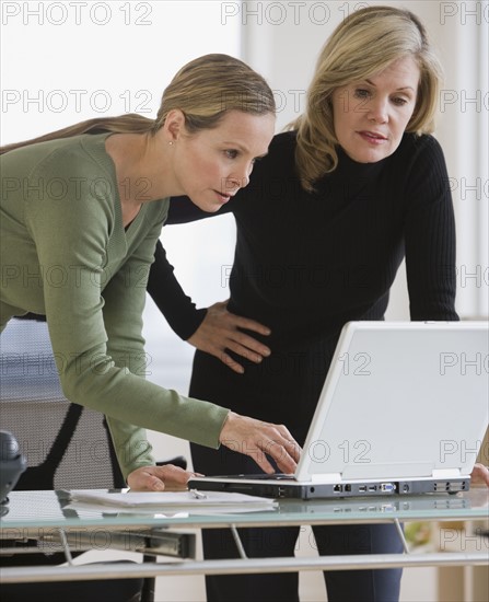 Businesswomen looking at laptop.