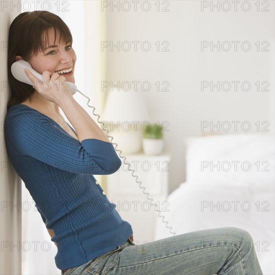 Woman talking on telephone.