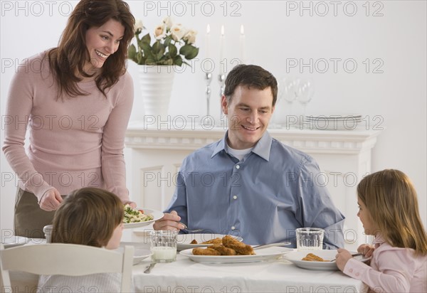 Family eating at dinner table.