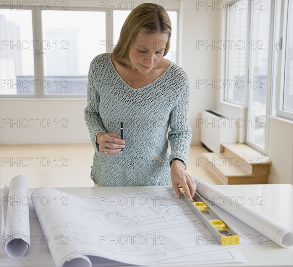 Woman looking at blueprints.