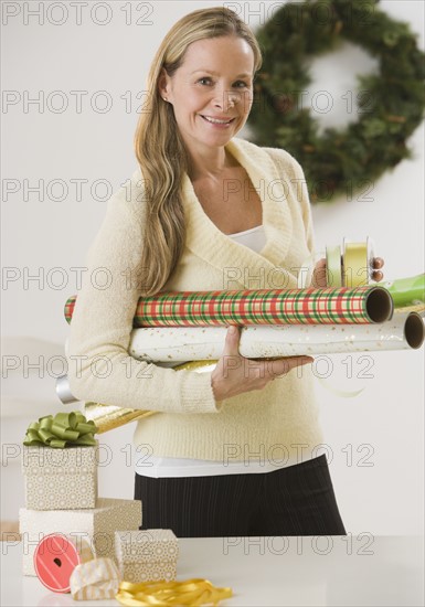 Woman carrying wrapping paper.