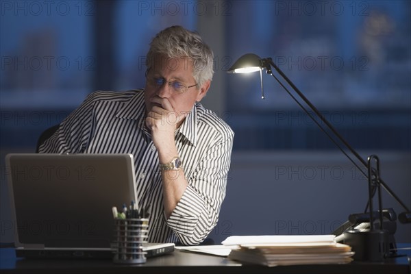 Businessman looking at laptop.