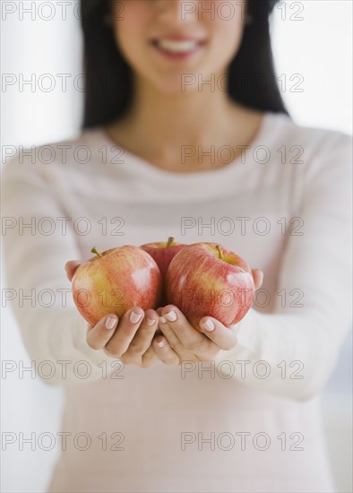 Woman holding apples.