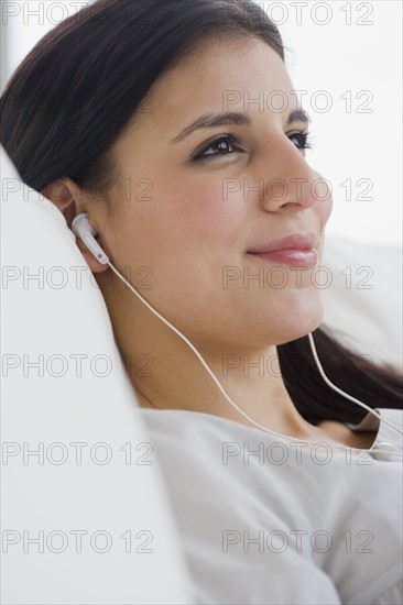 Woman listening to mp3 player.