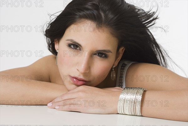 Woman leaning chin on hands.