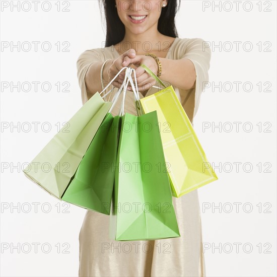 Woman holding out shopping bags.