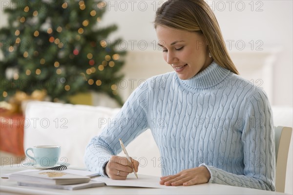 Woman writing at desk.