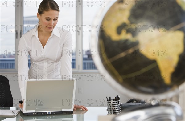 Businesswoman looking at laptop.