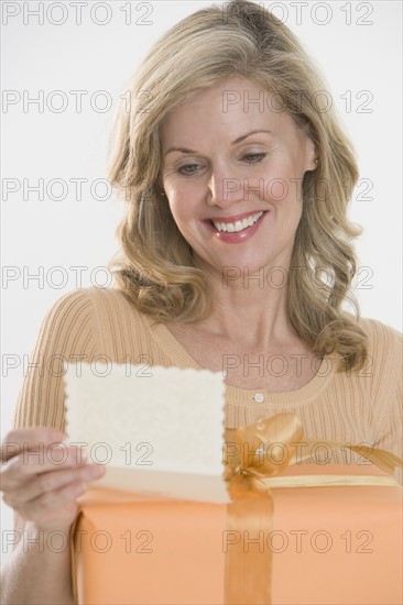Woman reading card on gift.