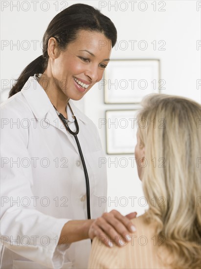 African female doctor reassuring patient.