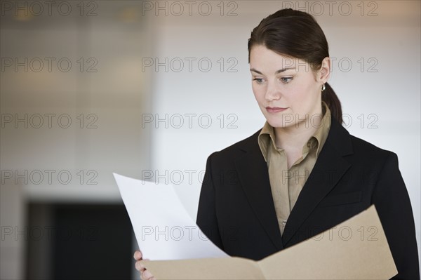 Businesswoman reading paperwork.