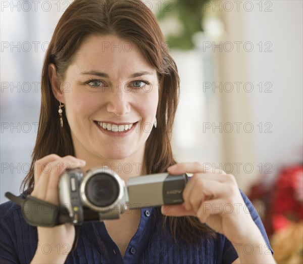 Woman holding video camera.