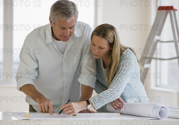 Couple looking at blueprints.