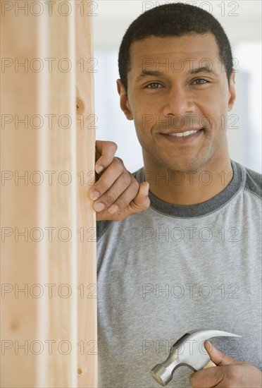 African man holding hammer.