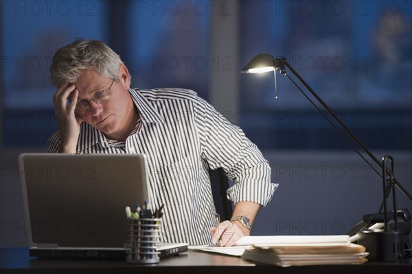 Businessman looking at laptop.