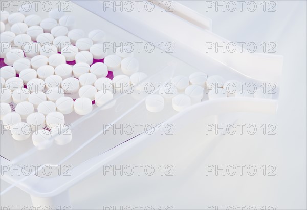 Close up of pills in measuring device.