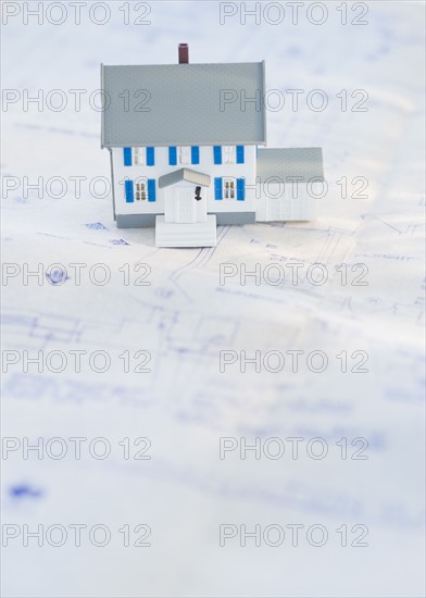 Model house on blueprints.