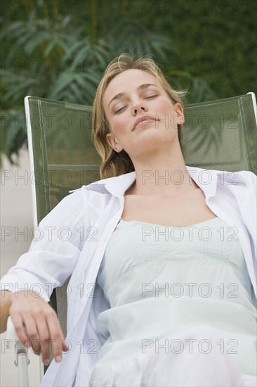 Woman relaxing in lounge chair.