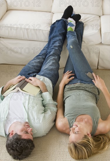Couple with feet up on sofa.