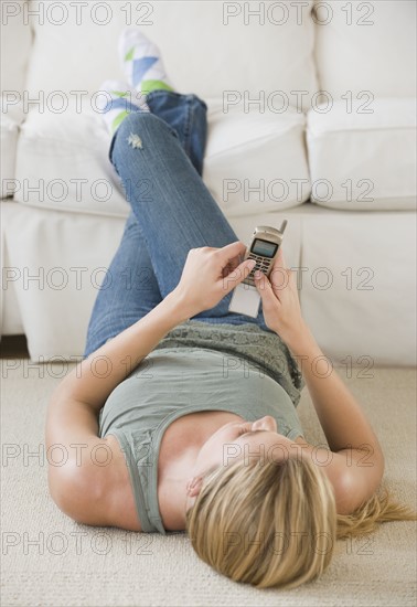 Woman dialing cell phone.