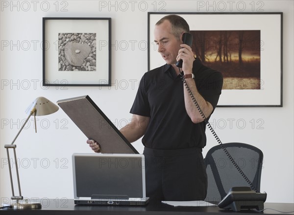 Businessman talking on telephone.