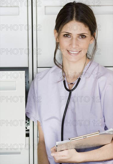 Female doctor holding chart. Date : 2008