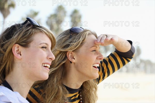 Two young women with sunglasses on head. Date : 2008