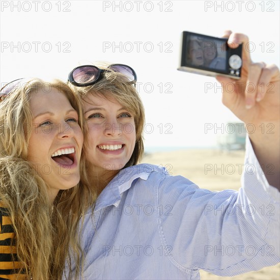 Two young women taking self-portrait. Date : 2008