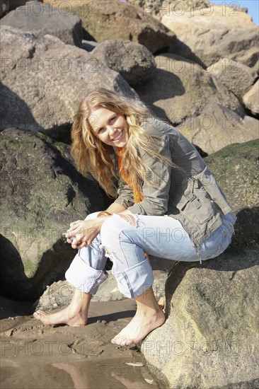 Woman sitting on rock. Date : 2008