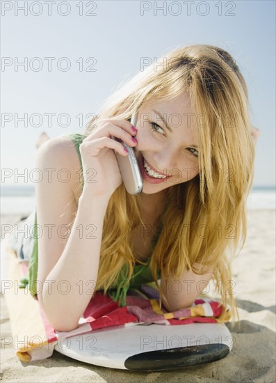 Woman talking on cell phone at beach. Date : 2008