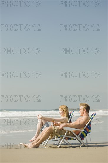 Couple sitting in beach chairs. Date : 2008