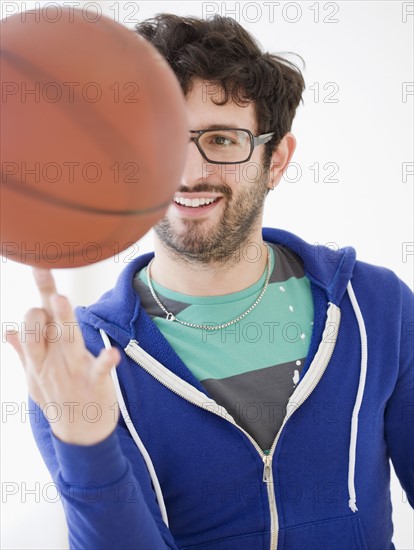 Man spinning basketball on finger. Date : 2008