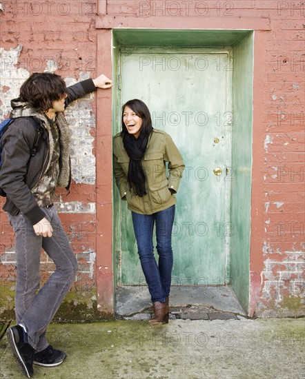 Couple talking in urban doorway. Date : 2008