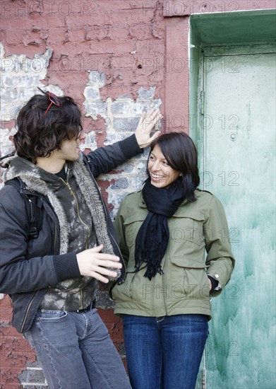 Couple talking in urban doorway. Date : 2008