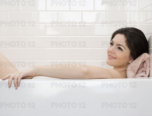 Woman laying in bathtub. Date : 2008