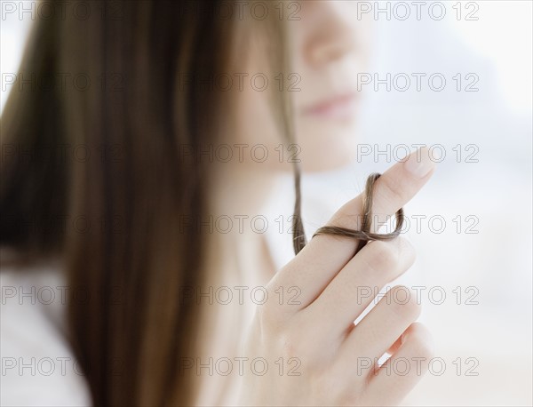 Woman with hair wrapped around finger. Date : 2008